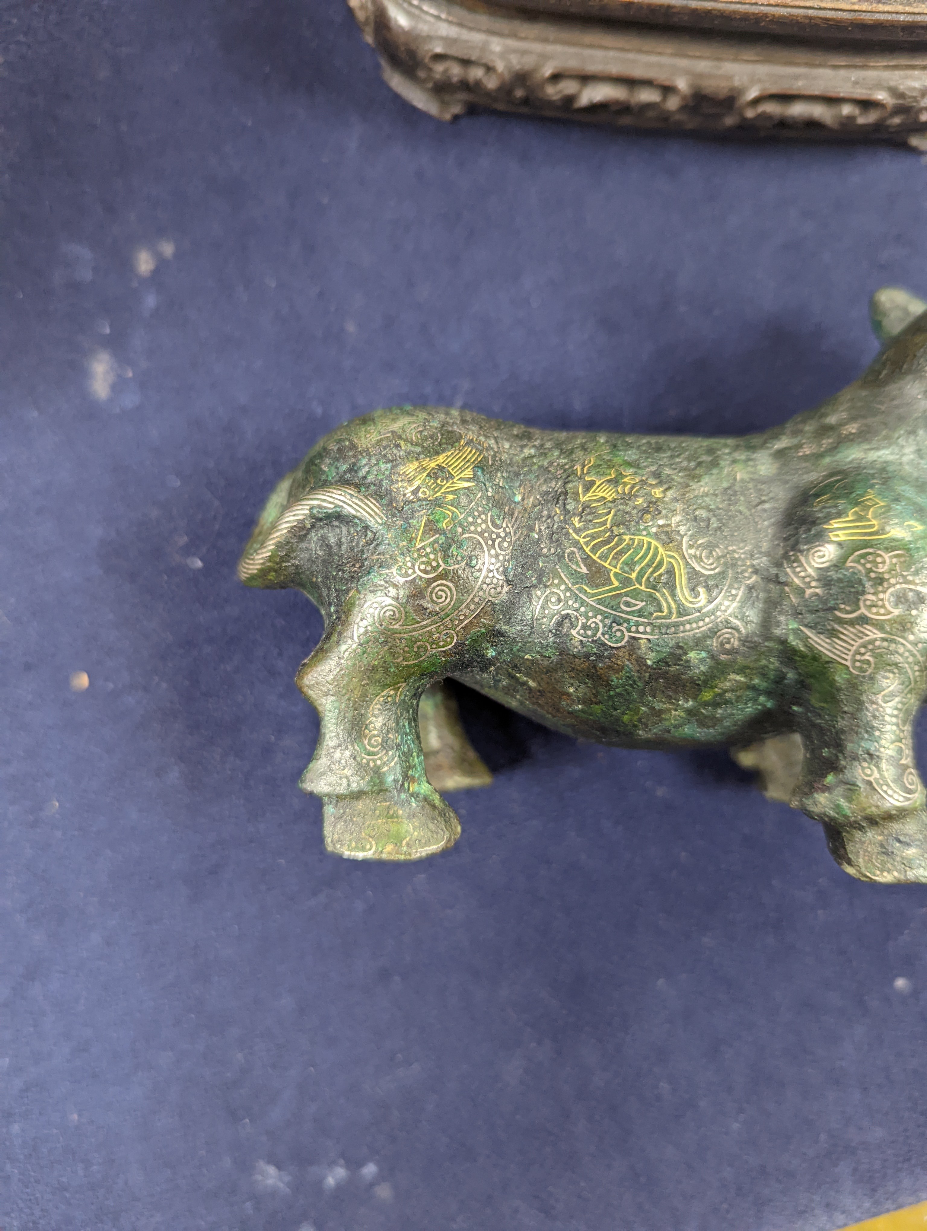 A Chinese gold and silver inlaid bronze figure of a tapir, Han dynasty or later, L. 12cm, excluding hardwood stand and fitted box